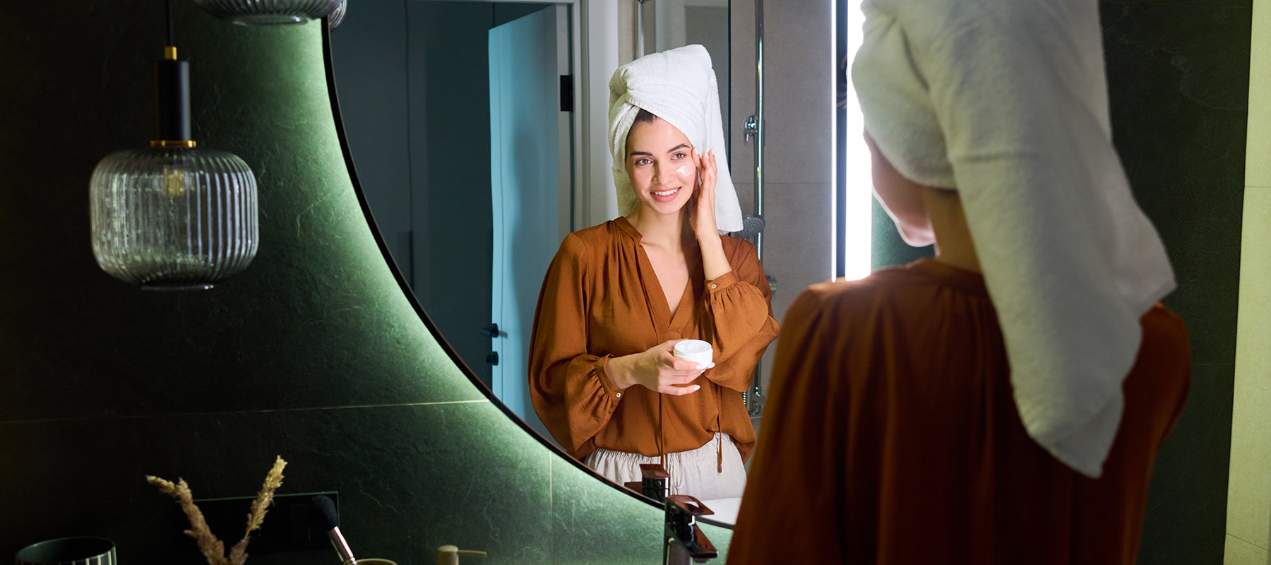 Close-up of a woman applying a spot treatment to acne-prone skin before bed