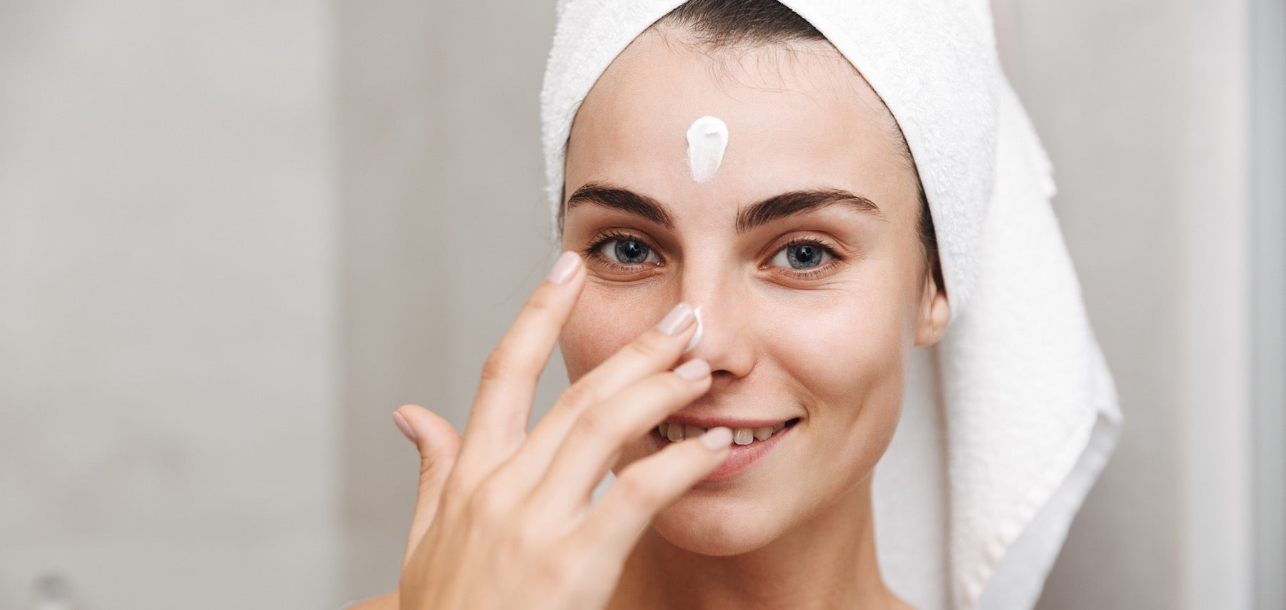 Woman applying CoQ10 serum during her nighttime skincare routine
