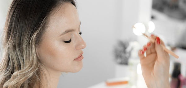 young woman getting eye makeup professionally done